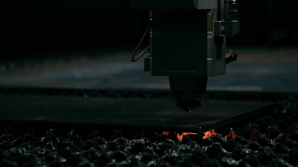 Plasma cutting of metal with a cnc. A plasma cutter cuts a workpiece from a sheet of metal. Laser cutter in production. Industrial metal cutting by plasma laser. 