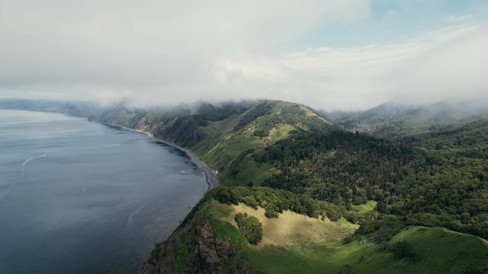 Vast oceanfront cliff edge offering panoramic views of rugged coastlines and rolling pastures